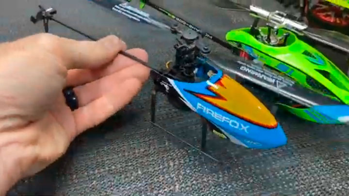 Hand holding tiny fixed-pitch model helicopter